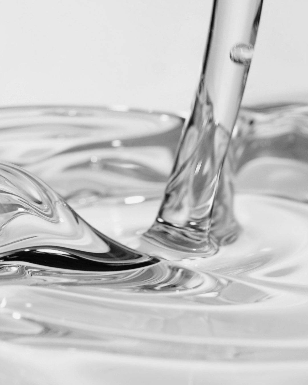 Close-up of a clear liquid representing moisturizers for face and body.