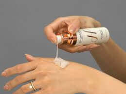 Applying Hydrinity Skincare advanced hydration repair skincare Canada product on hand.