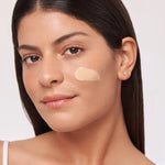 Model showcasing Alastin HydraTint Pro Mineral Broad Spectrum Sunscreen SPF 36 on her face for a hydrated, even tone.