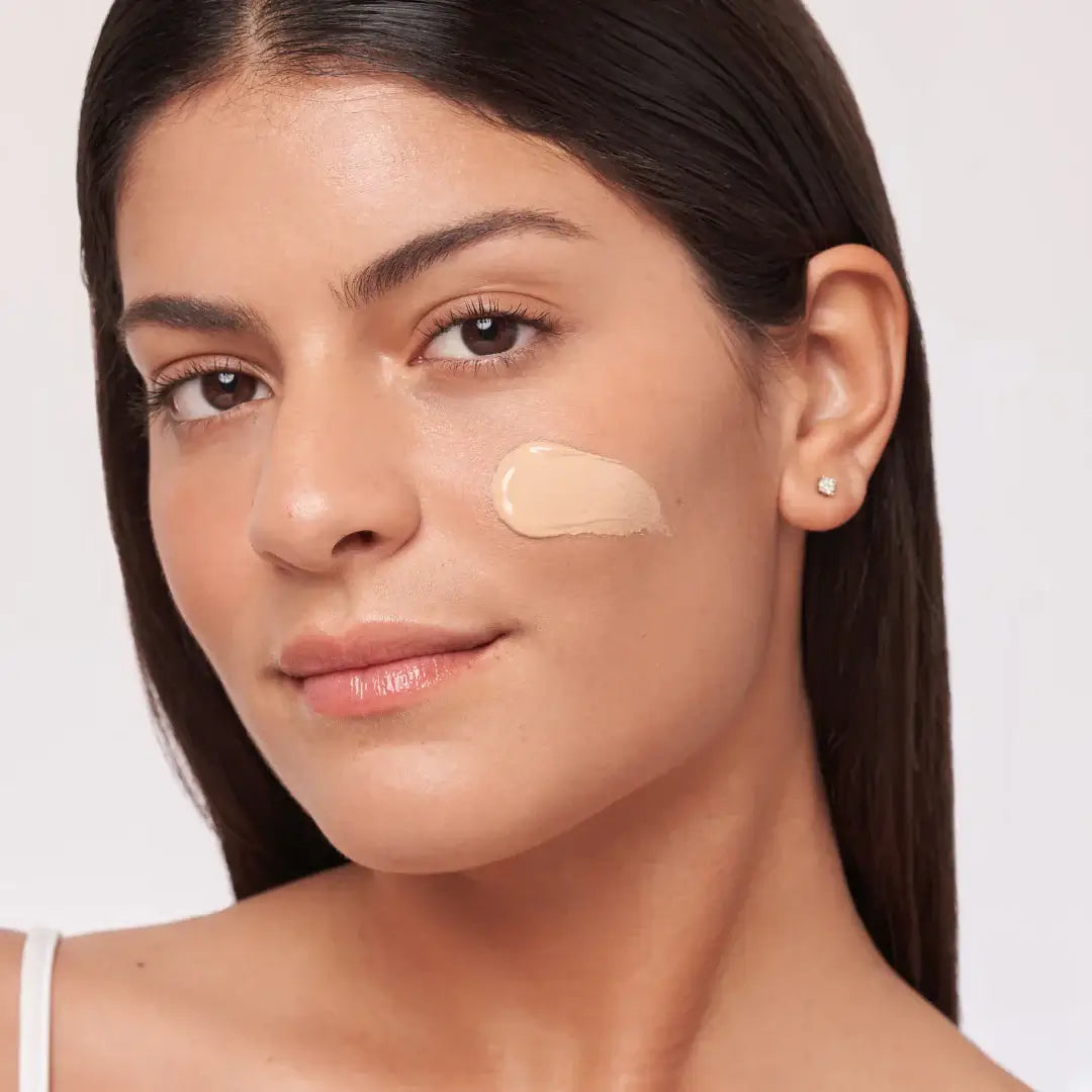 Model showcasing Alastin HydraTint Pro Mineral Broad Spectrum Sunscreen SPF 36 on her face for a hydrated, even tone.