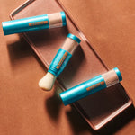 Colorescience Sunforgettable Total Protection Brush-On Shield Bronze SPF 50 product packaging on a bronze background.