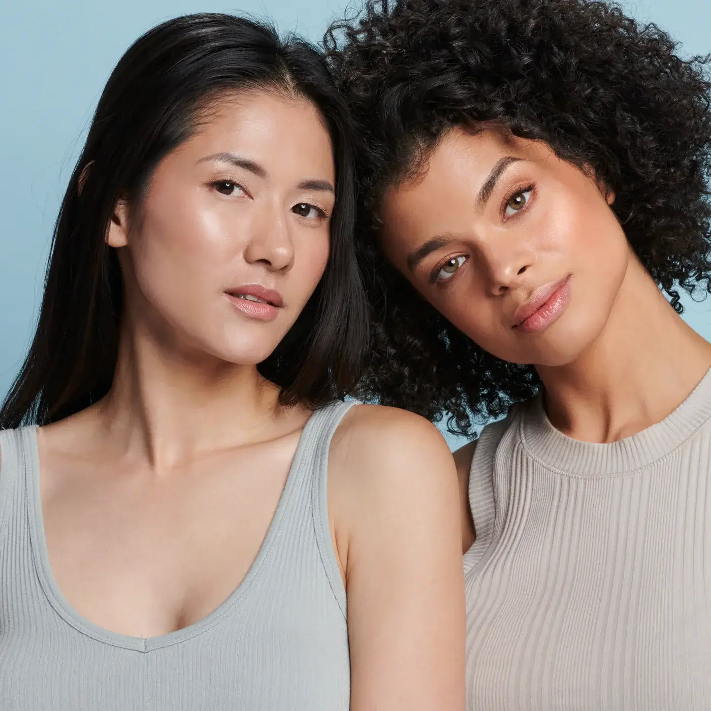 Two women showcasing radiant skin, promoting Colorescience Sunforgettable Total Protection Brush-On Shield Glow SPF 50.