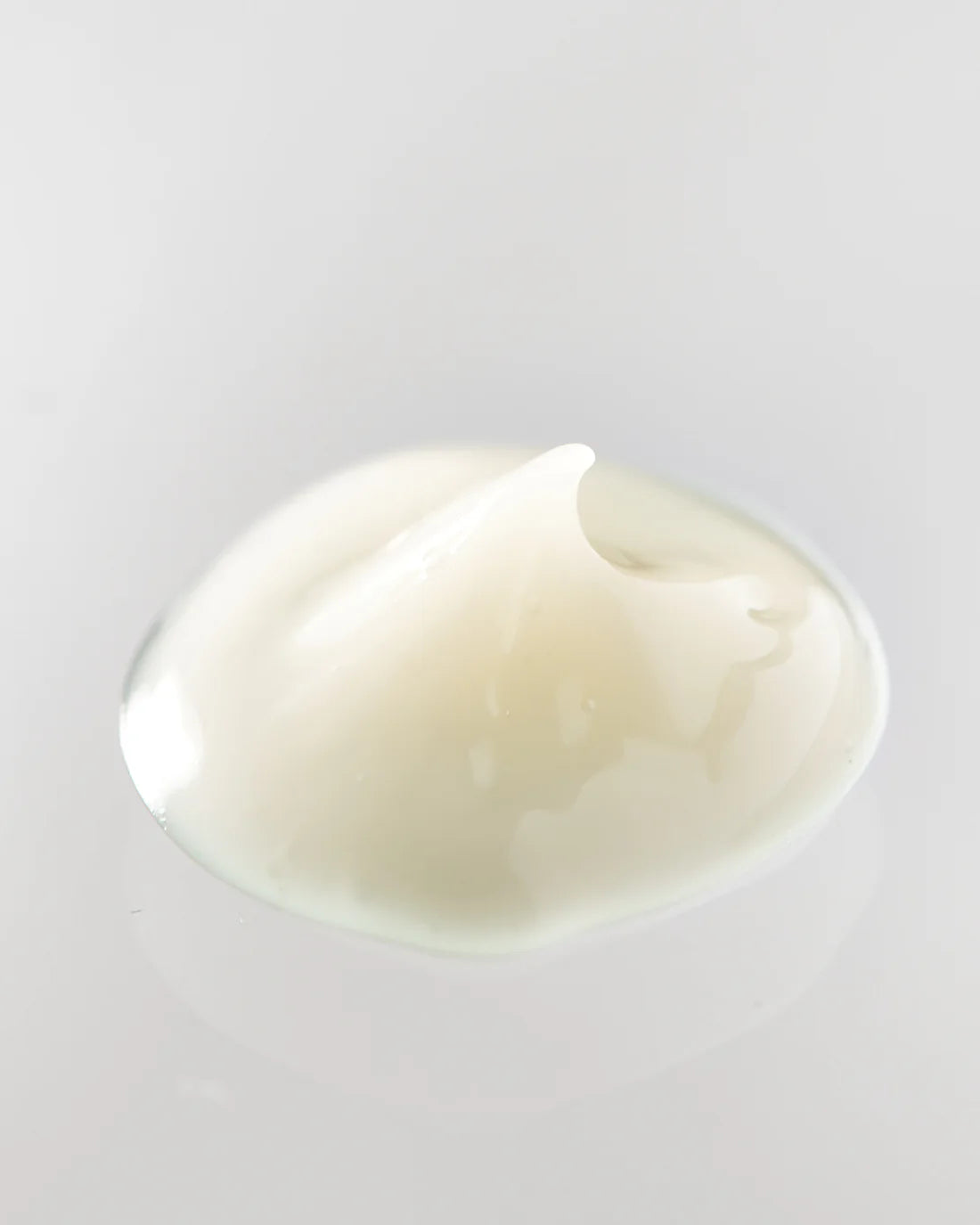 Young Goose EYEC.A.R.E. NAD+ Boosting Eye Cream swatch on a reflective surface.