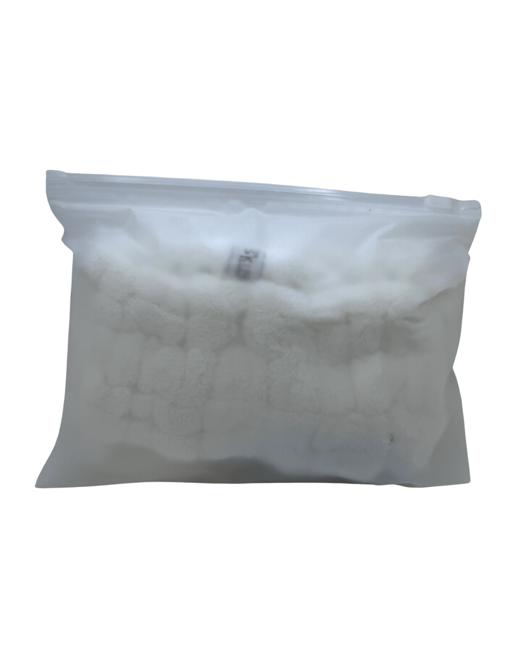 Plastic pouch containing plush wash headband and wrist cuff skincare set for effective beauty routines.