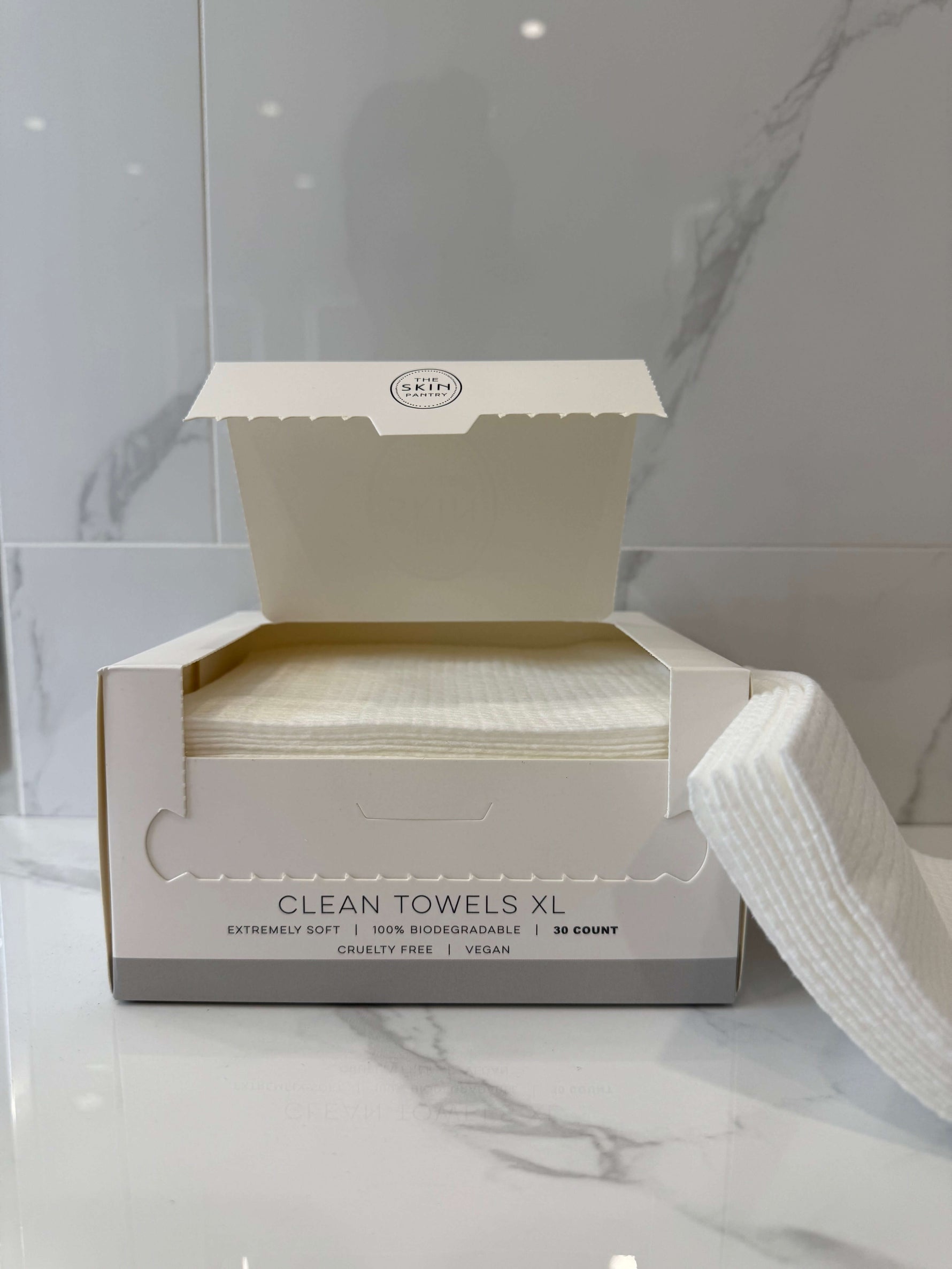 The Skin Pantry Clean Towels XL packaging opened, showcasing ultra-soft, biodegradable 30 count clean towels.