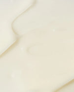 Vivier AHA BHA Exfoliating Cream texture shown on a smooth surface, highlighting its creamy formula for skincare.