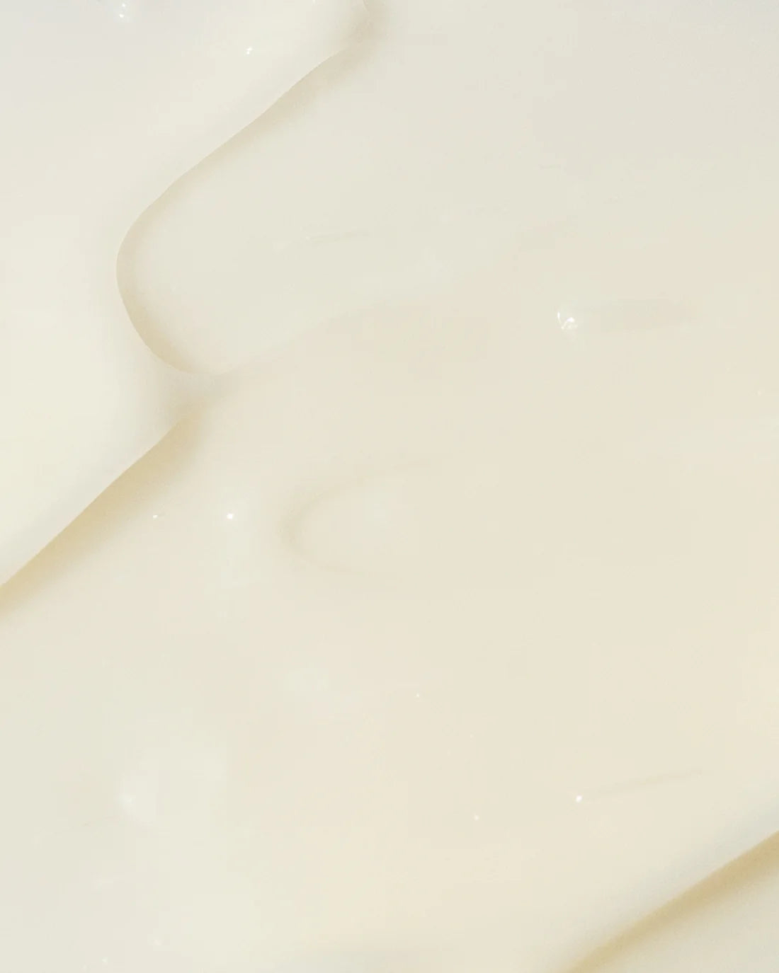 Vivier AHA BHA Exfoliating Cream texture shown on a smooth surface, highlighting its creamy formula for skincare.