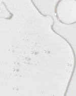 Close-up of Vivier Radiance Serum, showcasing its lightweight, smooth texture with shimmering droplets.
