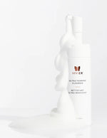 Vivier Ultra Foaming Cleanser bottle with foaming product spilling out on a clean backdrop.