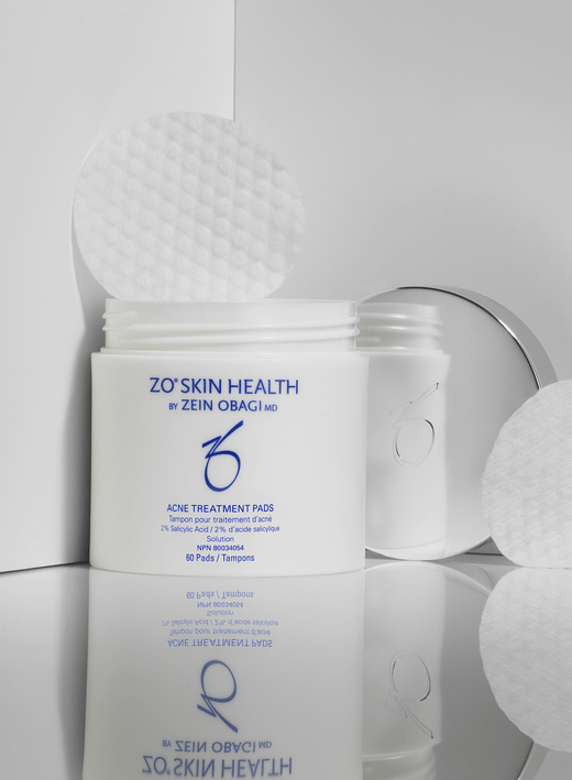 ZO Acne Treatment Pads in a jar with cotton pads for clear skin, featuring 2% salicylic acid for effective acne treatment.