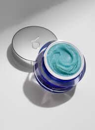 ZO Exfoliating Polish in a jar with a silver lid, featuring a bright blue exfoliating cream inside.